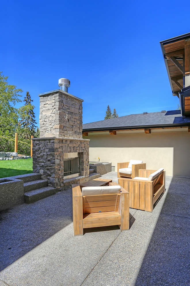 Outdoor wood burning fireplace This large exposed aggregate patio features a wood burning fireplace with natural stone surround Stone Sill Buff Limestone with pitched edges Outdoor wood burning fireplace #Outdoorwoodburningfireplace