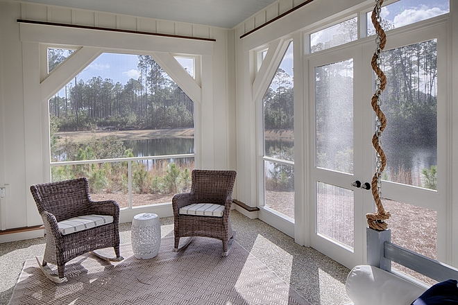 Screened porch with rocking wicker chairs and swing bed great way to create comfort in a small screened porch #screenedporch #smallscreenedporch