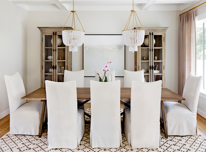 Dining Room Two Chandeliers This is the type of dining room I love - it's very comfy and it feels collected without being too precious #diningroom #chandeliers #linenchairs #cofferedceiling #rug #diningtable #linencurtains