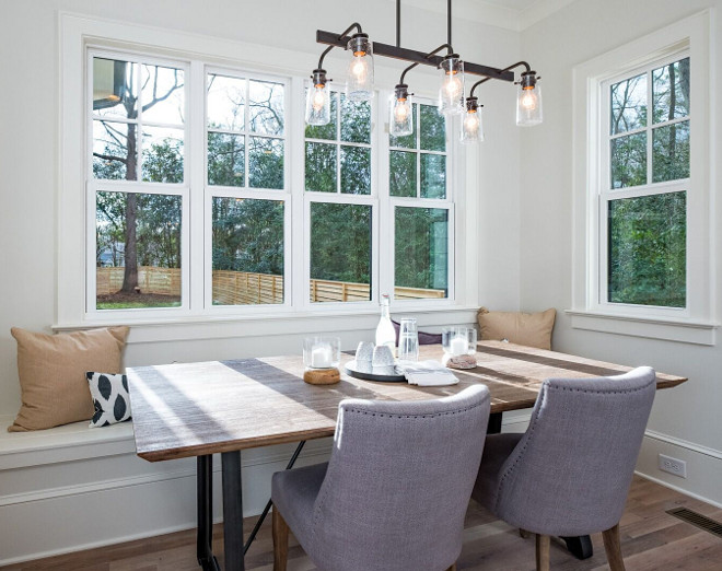 Farmhouse Breakfast Nook with industrial linear chandelier and built-in banquette #farmhousebreakfastnook #breakfastnook #banquette #farmhouselighting #industriallinearchandelier