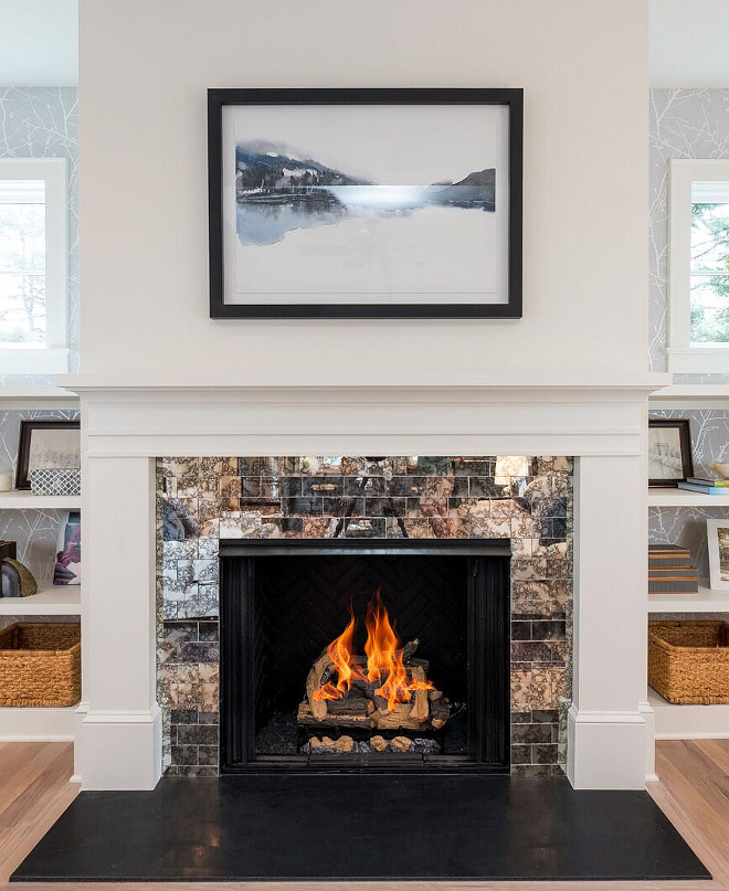 Fireplace features antique subway tile and leathered black granite