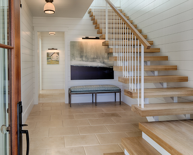 White Oak Floating Staircase with shiplap paneling The foyer features shiplap, honed and pillowed Travertine floor tile and floating stairs with thick White Oak treads #foyer #shiplap #floatingstaircase #whiteoakstaircase