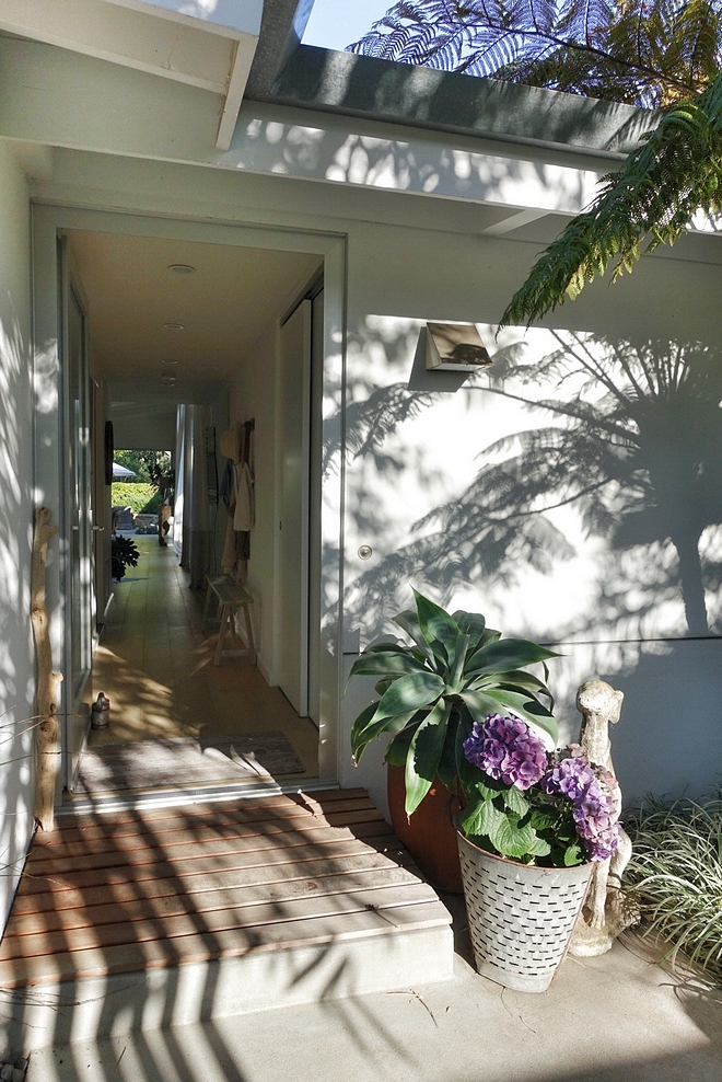 Ranch Home Ranch Home Front Door Foyer An aluminum and glass front door opens to a long hall leading to the main rooms with direct view to the lush backyard #Ranchhome #foyer #frontdoor #hall #aluminumdoor