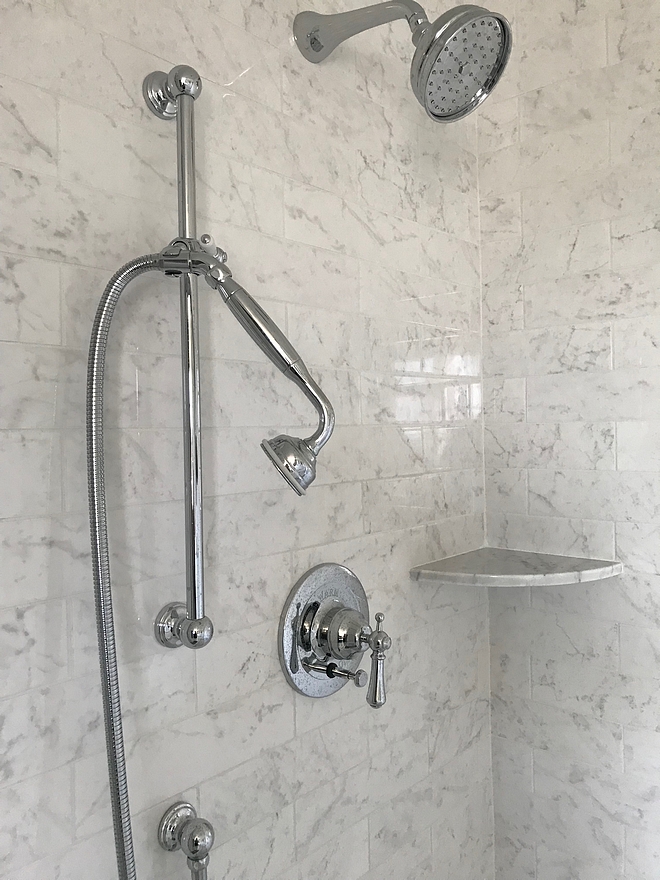 The shower features a Perrin & Rowe Georgian Era Pressure Balance Trim Kit with a diverter and a wall mounted shower arm on a sliding rail A Rohl 5 inch Bordano showerhead completes the look