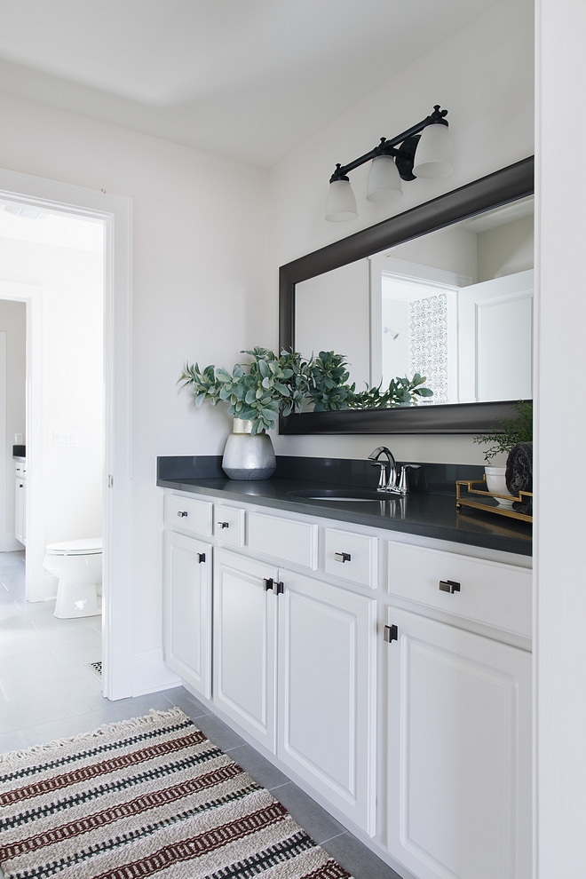 Bathroom Keeping the cabinets white keeps with the classic look and will appeal to most buyers Countertop is a dark grey quartz #bathroom