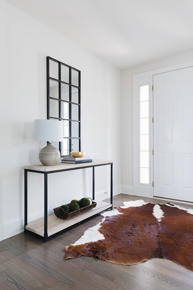 Benjamin Moore Classic Gray The front door opens to a bright foyer with light grey walls, Benjamin Moore Classic Gray, and beautiful hardwood flooring Benjamin Moore Classic Gray Benjamin Moore Classic Gray #BenjaminMooreClassicGray #lightgreywall #paintcolor #lightgrey #BenjaminMoore