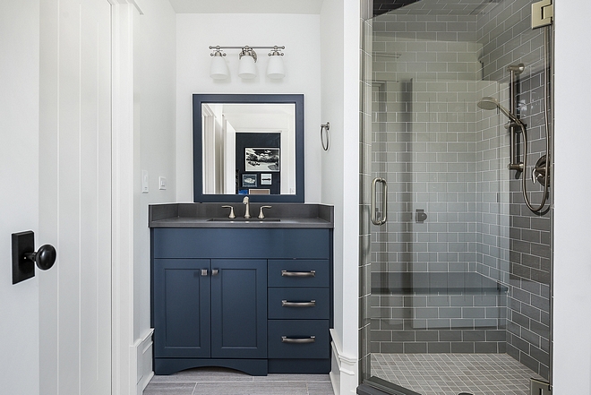 Naval by Sherwin Williams Boys bathroom with navy blue vanity painted in Naval by Sherwin Williams #NavalbySherwinWilliams