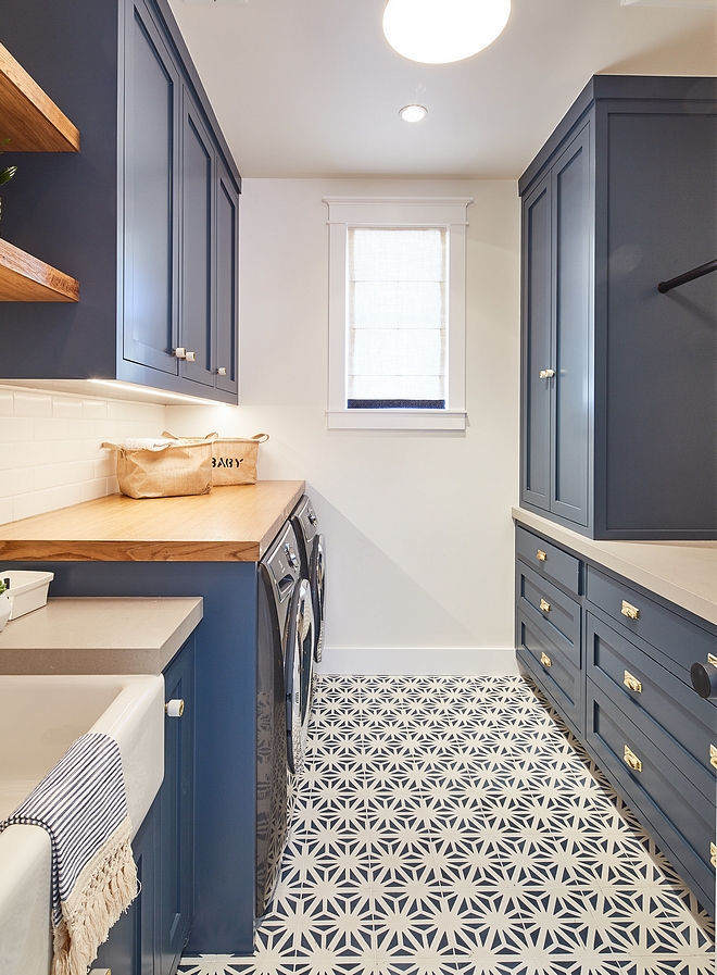 Navy Laundry Room Cabinets painted in Dunn-Edwards DE5824 Outer Space and flooring covered in navy and white cement tile Navy Laundry Room Navy Cabinet #navylaundryroom #laundryroom #cabinets #DunnEdwardsDE5824OuterSpace