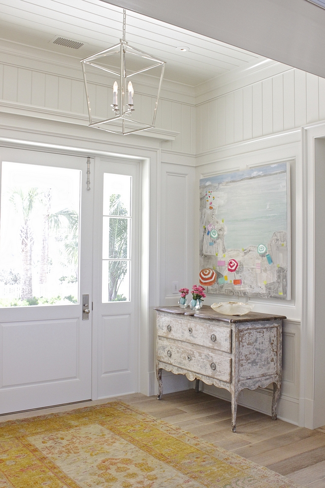 Benjamin Moore White Dove Foyer cWalls and ceiling feature a combination of traditional wainscoting and tongue and groove paneling #BenjaminMooreWhiteDove #traditionalwainscoting #paintcolor #tongueandgroove