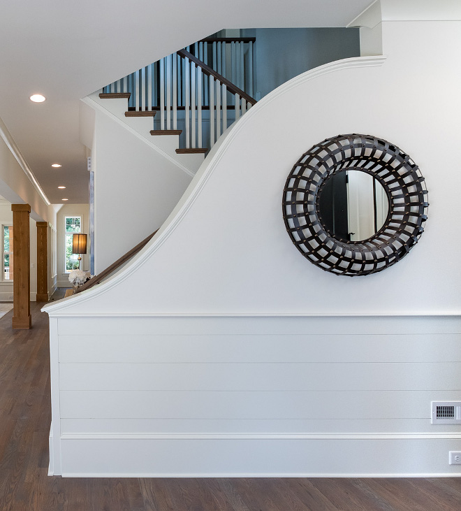 Foyer Wainscoting We didn't want to have to walk in and see a boring stair railing and balusters, so we opted for this one of a kind curved railing that hides the stairway just enough and provides for a WOW factor upon entering the home Shiplap wainscoting was a must #Wainscoting #Staircasewainscoting #FoyerWainscoting
