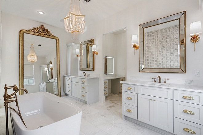Master Bathroom The master bathroom is truly breathtaking Grey vanities are complemented with brass hardware and marble tiling adds a traditional and timeless feel to the space #masterbathroom #greyvanities