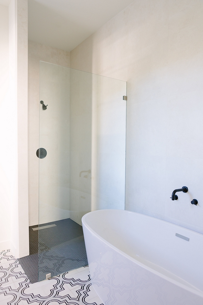 Curbless Shower This bathroom also features a simple curbless shower and a freestanding tub #CurblessShower
