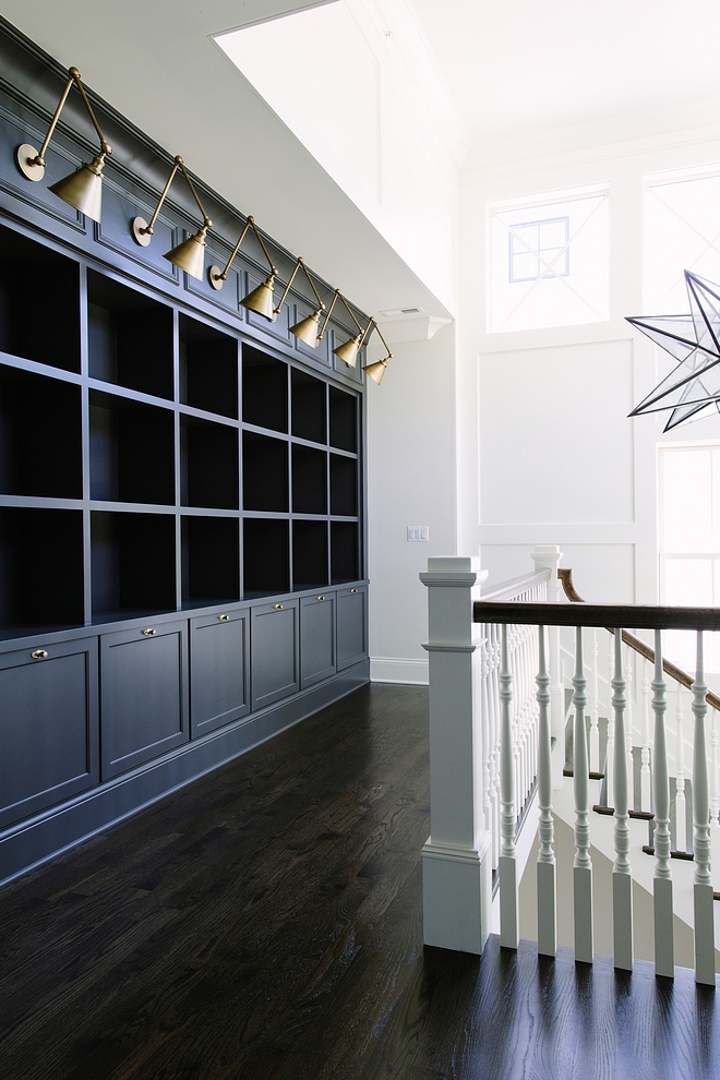 Benjamin Moore Iron Mountain The second floor features a 14’ built-in cabinetry and bookcase with library lighting #BenjaminMooreIronMountainr #BenjaminMoorepaintcolor