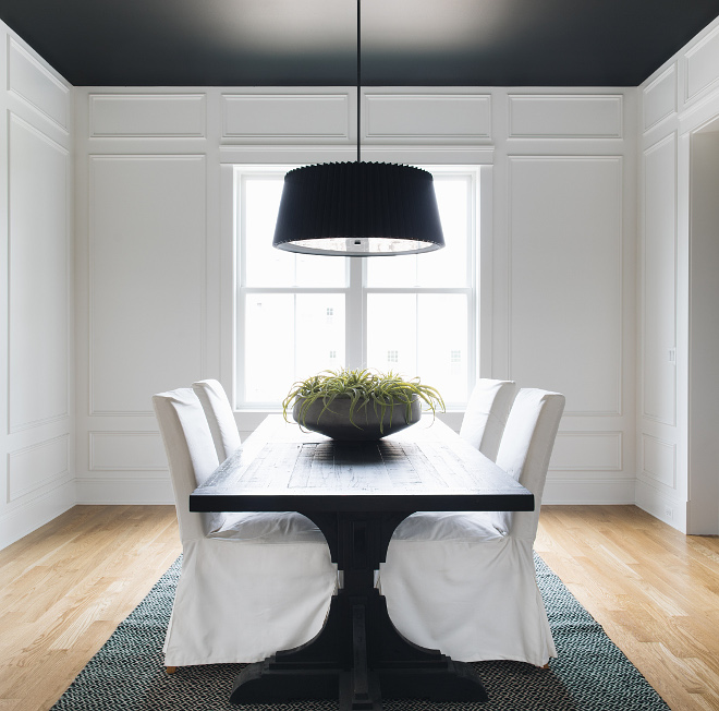 Dining room with white paneling wall painted in Benjamin Moore Simply White Ceiling paint color is Benjamin Moore Black #diningroom #paneling #paintcolor #BenjaminMooreSimplyWhite