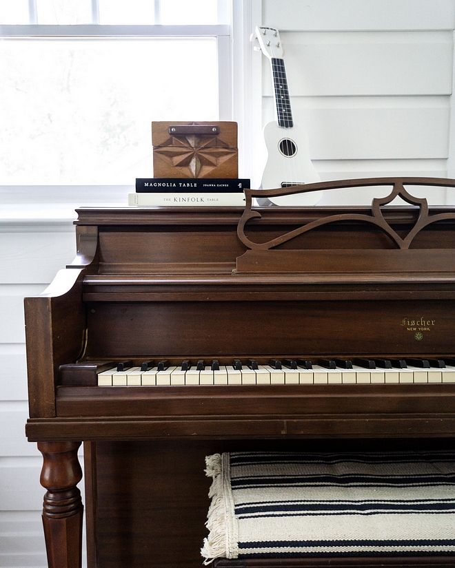 Vintage piano kept in natural color beatiful against white walls