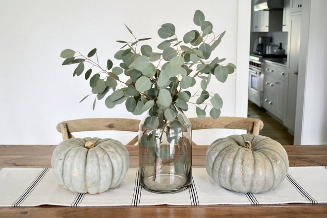 A simple centerpiece of fresh eucalyptus and heirloom pumpkins set the tone for our informal dining space
