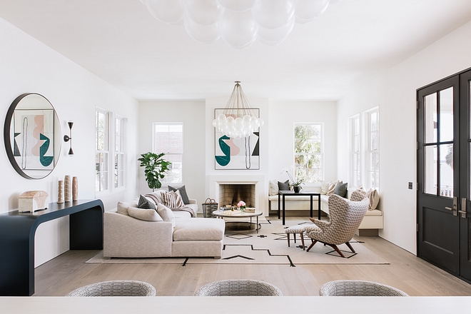 Ecclectic Living room featuring large sectional, glass buble chandelier and mid-century accent chair #livingroom #ecclecticinteriors