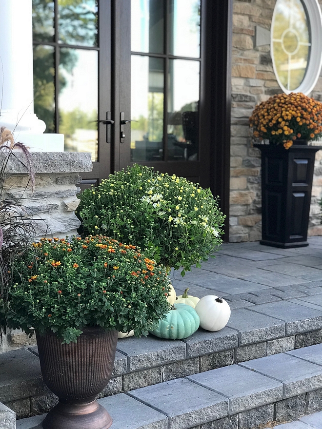 Fall Porch I’ve always found decorating for fall fun although I like to keep decor simple. I add some colourful mums from our local nursery that compliment the exterior colour of the stone, and add pumpkins from Michael #Fall #porch #mums