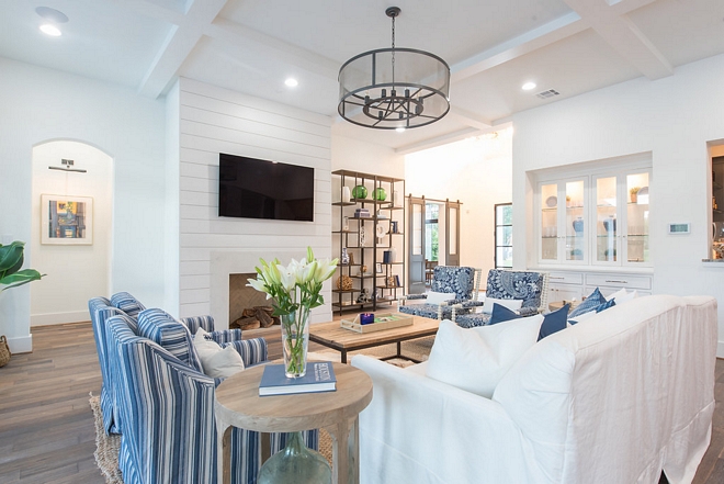 The foyer opens to a beautifully designed living room with coffered ceiling and shiplap fireplace #livingroom #cofferedceiling #shiplapfireplace