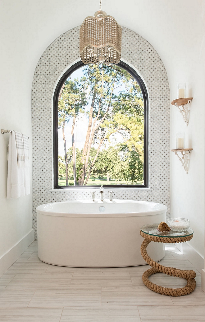 Arched Bath Nook Arched Bath Nook with marble mosaic accent tile, freestanding tub, arched window and beaded chandelier Arched Bath Nook #ArchedBathNook #ArchedNook #BathNook
