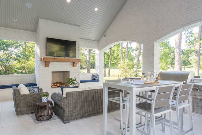 The outdoor brick fireplace is painted in Sherwin Williams Toque White