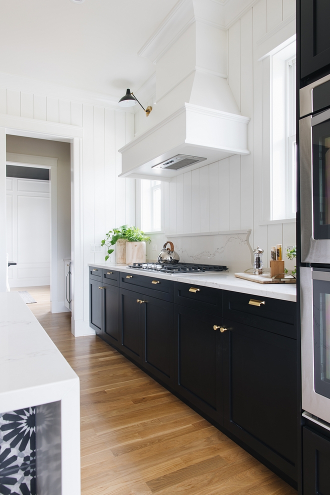 Kitchen Hood By painting the hood white it blends in to the white walls but at the same time stands out from the rest of the black cabinetry #kitchenhood #hood #twotonekitchen #hood #kitchen