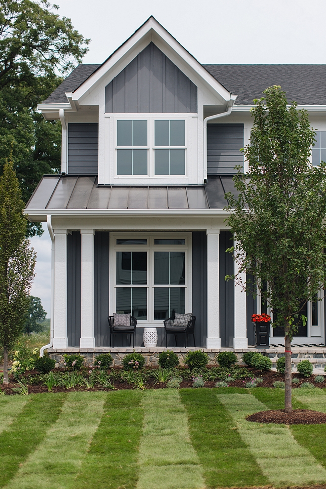 Grey Home Exterior with grey board and batten siding and white trim white porch columns and metal roof #GreyHome #GreyExterior #greyboardandbattensiding
