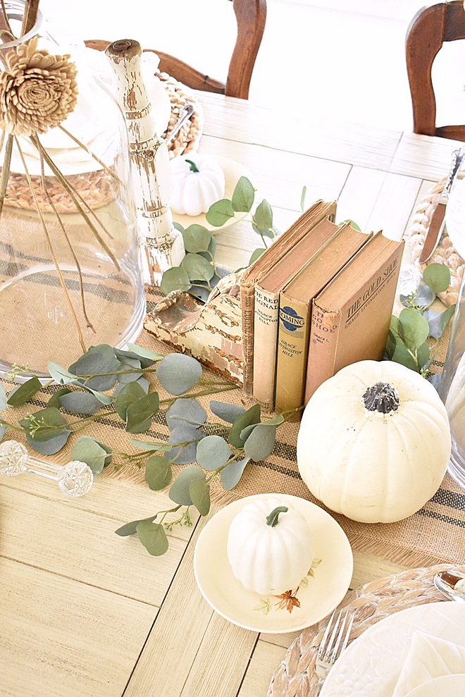 Neutral Fall Tablescape with white pumpkins vintage books and eucalyptus