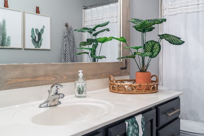 Bathroom countertop decor with rattan tray and greenery