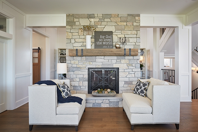 Settes in front of natural stone fireplace with beam mantel #settes #settee #fireplace #beammantel