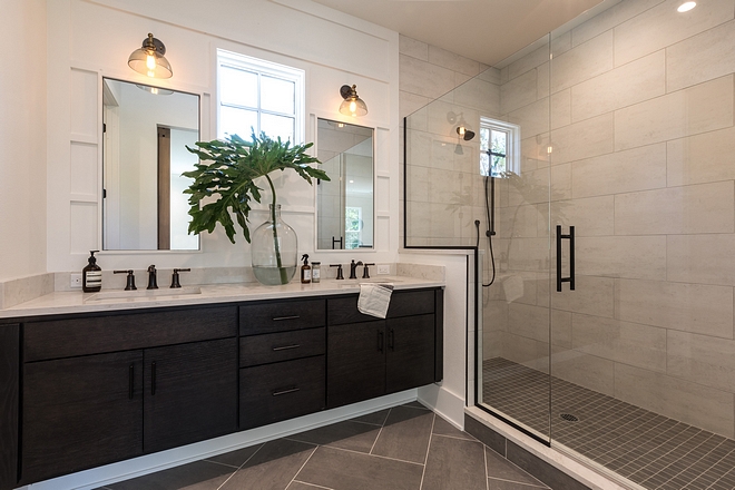 Modern farmhouse bathroom with large shower with 12x24 tile, herringbone floor tile, floating bathroom vanity and vertical board and batten accent wall #masterbathroom #boardandbatten #modernfarmhousebathroom #floatingvanity