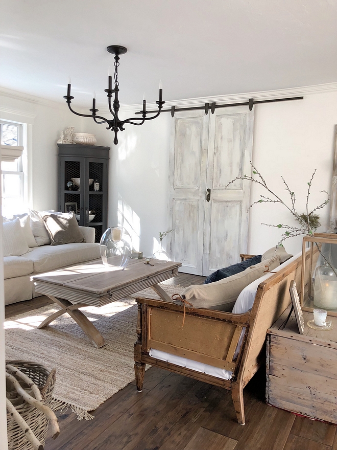 Distressed Barn Door Hides the Tv in this living room Distressed Barn Door #DistressedBarnDoor 