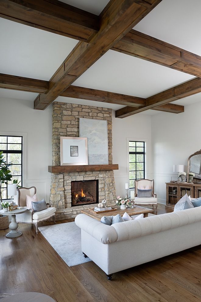 French Country Living room Hardwood flooring is Rustic Hickory planks finished on site The beams are alder and the stone veneer used on fireplace is similar to Montana Quartz #FrenchCountryLivingroom #Hardwoodflooring #beams #stonefireplace #Frenchcountry #interiors #livingroom