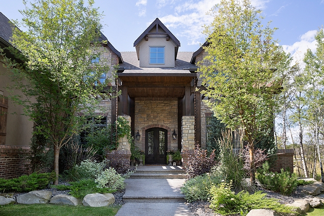 Curb appeal This home has a very grand, but inviting curb appeal with large double iron front doors and a front veranda #curbappeal