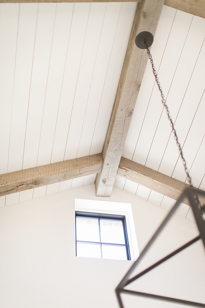 Plank Ceiling Ceiling is clad with white planking and reclaimed beams #PlankCeiling #Ceiling #beams