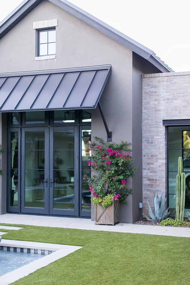Exterior Grey stucco with Brick, metal roof and black steel doors and windows Exterior brick is General Shale Ironworks