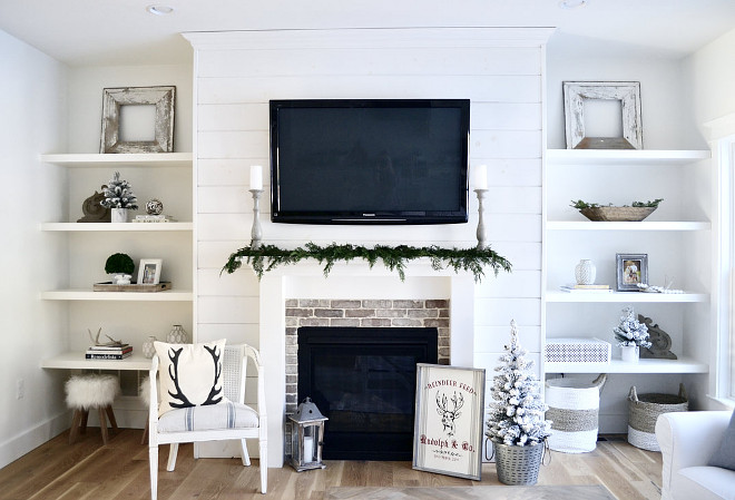 Family Room Christmas decor In our family room, I used live cedar garland across our mantle and added accents such as a white flocked trees and an antler pillow from a local shop #familyroom #Chirstmas #Christmas