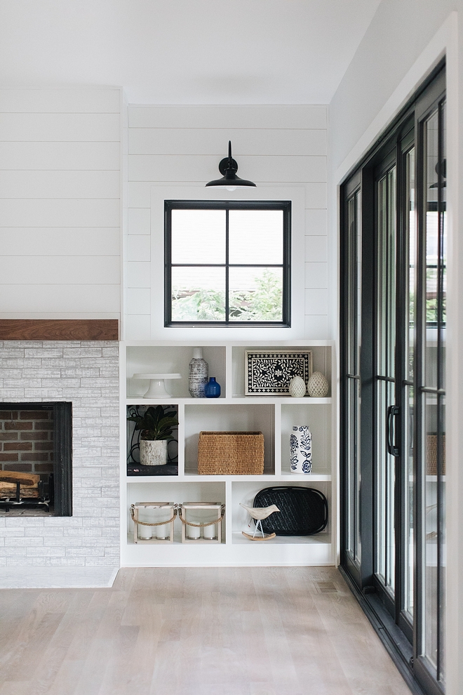 Fireplace built-ins The fireplace is flanked by asymmetrical built-ins with windows and shiplap above #fireplace #builtins #shiplap #windowabovebuiltin #asymmetricalbuiltin