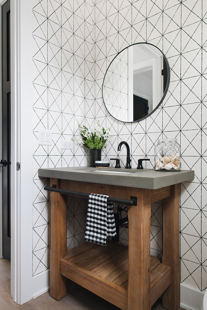 Chunky wood vanity This chunky wood vanity with concrete countertop brings a rustic feel to this monochromatic powder room with black and white geometric wallpaper #chunckywoodvanity #chunckywood #blackandwhitegeometricwallpaper #blackandwhitewallpaper #geometricwallpaper
