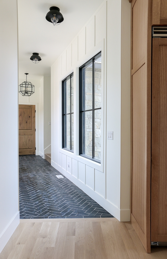 Benjamin Moore Simply White OC-117 The back entry features a stone herringbone floor tile and board and batten walls painted in Benjamin Moore Simply White OC-117 #BenjaminMooreSimplyWhiteOC117
