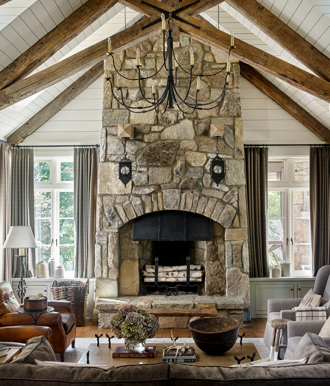 Stone Fireplace Stone Weathered Granite Stone Fireplace The fireplace design was inspired by an image the architect saw many years back in an old Arts and Crafts book Notice the two timbers projecting out of the fireplace where the sconces were hung #StoneFireplace #fireplace #WeatheredGranite