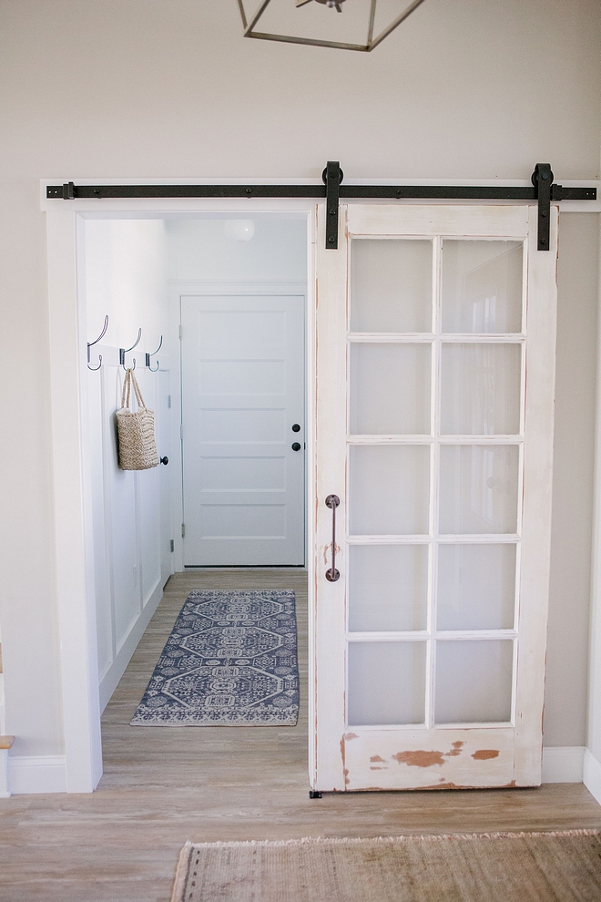 Antique door hung as barn door in laundry room I made sure to incorporate some of my favorite antique and vintage finds into every space of our home, especially the addition of the barn doors #Antiquedoor #barndoor #laundryroom