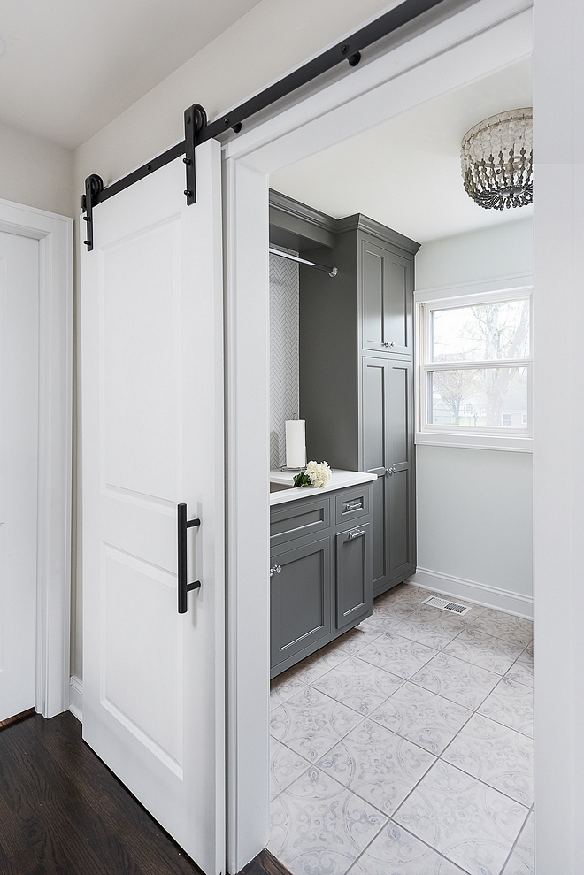 Grey laundry room Renovated Laundry room Upstairs you will find a newly-renovated laundry room with sliding barn door and dark grey cabinets. Trim, walls and barn door are painted in Benjamin Moore Super White #laundryroomrenovation #laundryroom #renovation #Greylaundryroom #RenovatedLaundryroom
