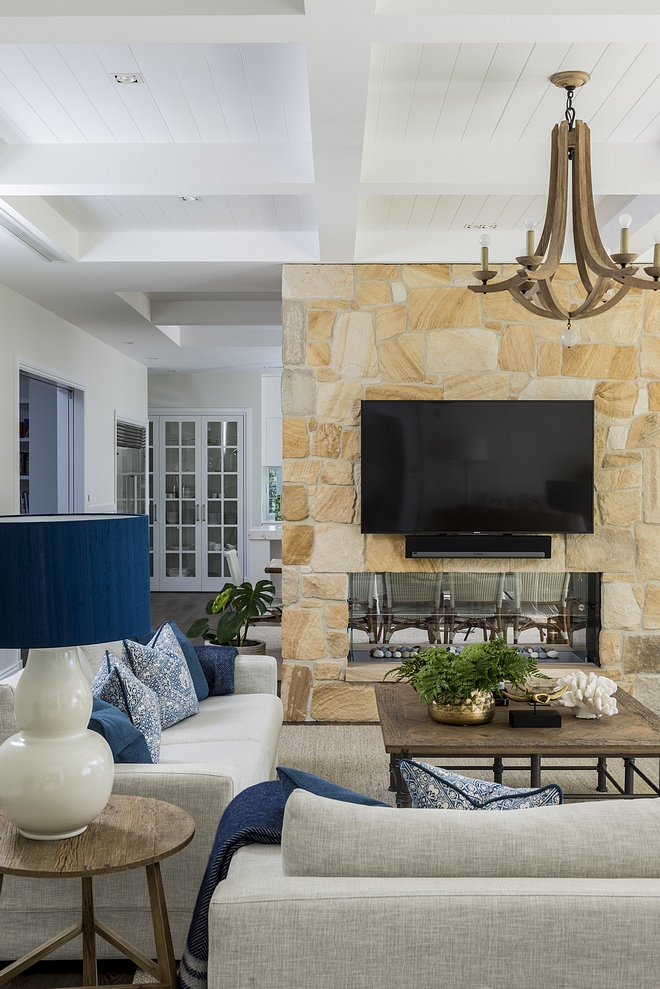 Sandstoe fireplace A double-sided Sandstone fireplace separates the living room from the kitchen #sandstone #sandstonefireplace #doublesidedfireplace #fireplace