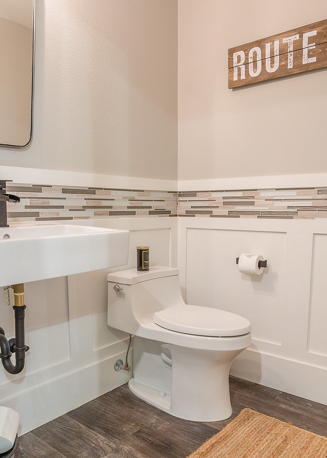 Powder room Paint color is Repose Grey SW 7015 by Sherwin Williams. Wainscoting is Super White by Benjamin Moore. Notice that a mosaic tile was placed just above the wainscoting #powderroom #wainscoting