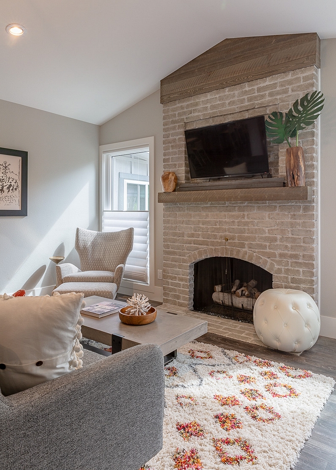 Original brick fireplace remodel The original brick fireplace had the brick "whitewashed" and a reclaimed wood beam was added See the before pictures on Home Bunch #originalbrickfireplace #brickfireplace #brick #fireplace