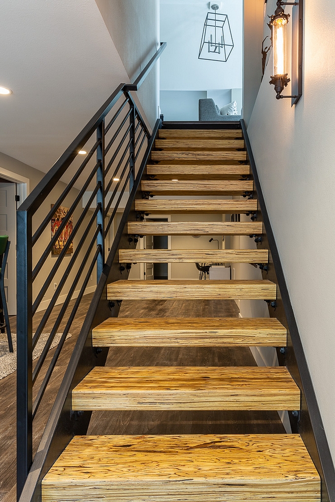 Metal staircase The staircase was replaced with a custom metal staircase with beam treads in a clear finish The beam treads are an engineered laminate lumber, often used as structural beams and posts #Metalstaircase #beams #treads