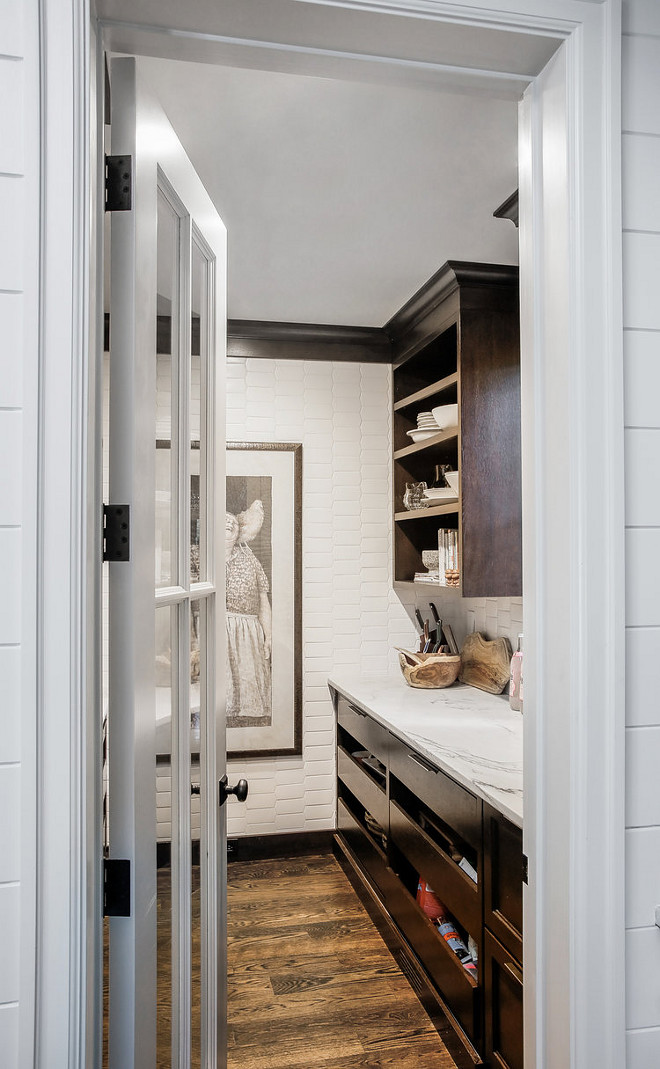 Farmhouse Pantry Farmhouse walk in pantry with elongated picket tile Farmhouse Pantry Farmhouse walk in pantry with elongated picket tile and dark stained wood cabinets #FarmhousePantry #pantry #walkinpantry #elongatedpickettile #Farmhouse #pantry #kitchenpantry