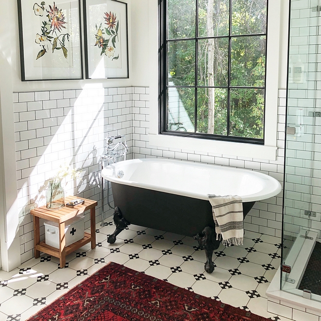 Black and white bathroom We knew we wanted a clawfoot tub to add that vintage feel Black and white clawfoot tub with white subway wainscoting tile, black and white cement floor tile and black window #Blackandwhitebathroom #bathroom
