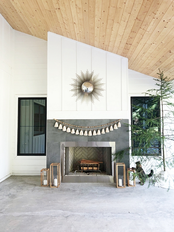 The outdoor fireplace mimics the living room's fireplace, featuring the same tiling and board and batten paneling #fireplacetiling #outdoorfireplace #fireplace #boardandbatten